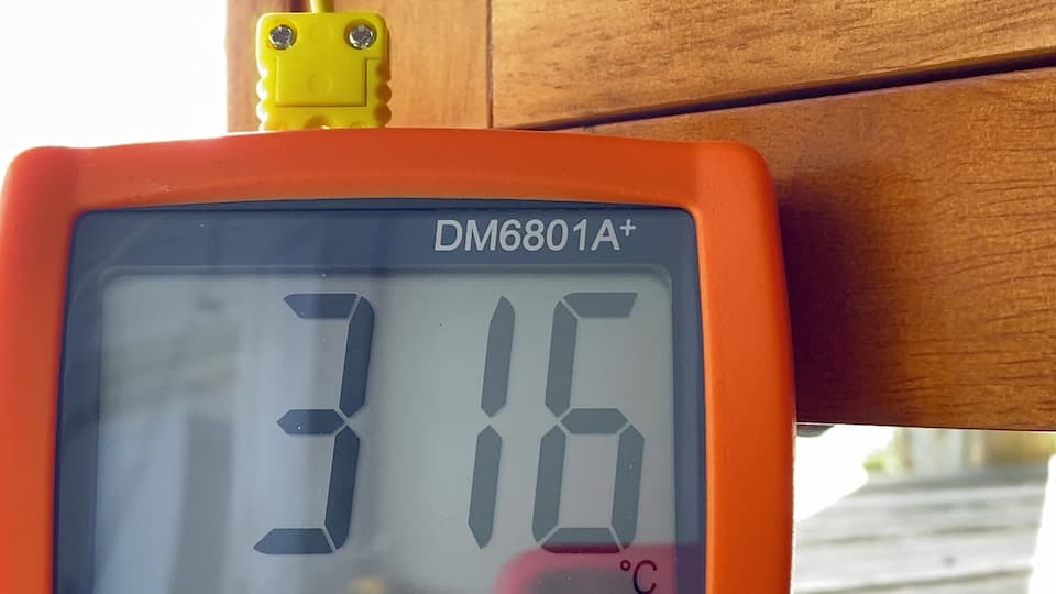 A close up of the screen of a digital thermometer. The model name is DM6801A+, then a large LCD shows 316, then a small C below it.
