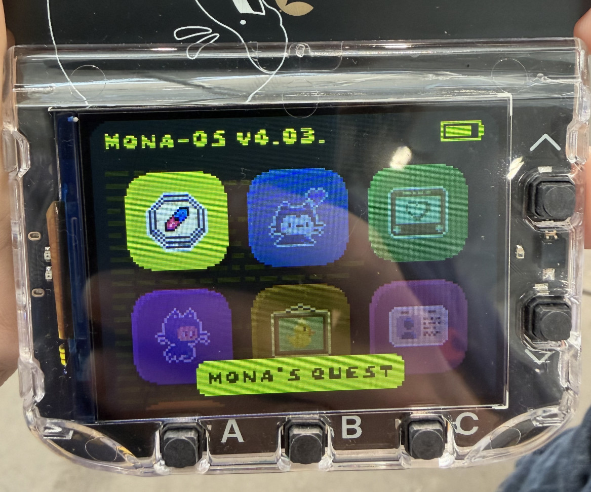 Photo of the badge - it has a color screen with six app icons
